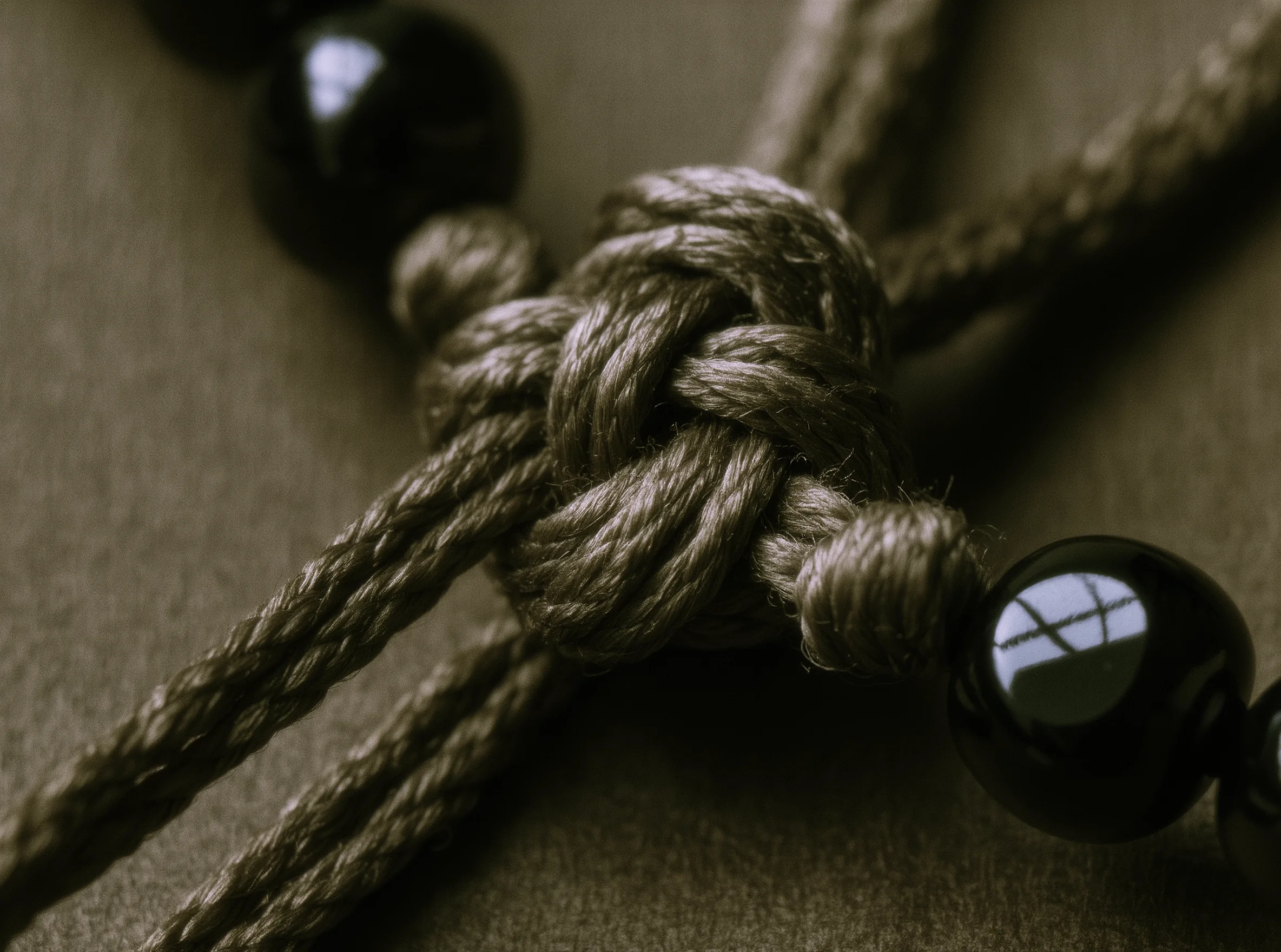 The Unseen Strength: The Theology of the Artisan Cord 2 Artisan Cord by Yuano: A macro study of hand-knotted silk representing unseen strength