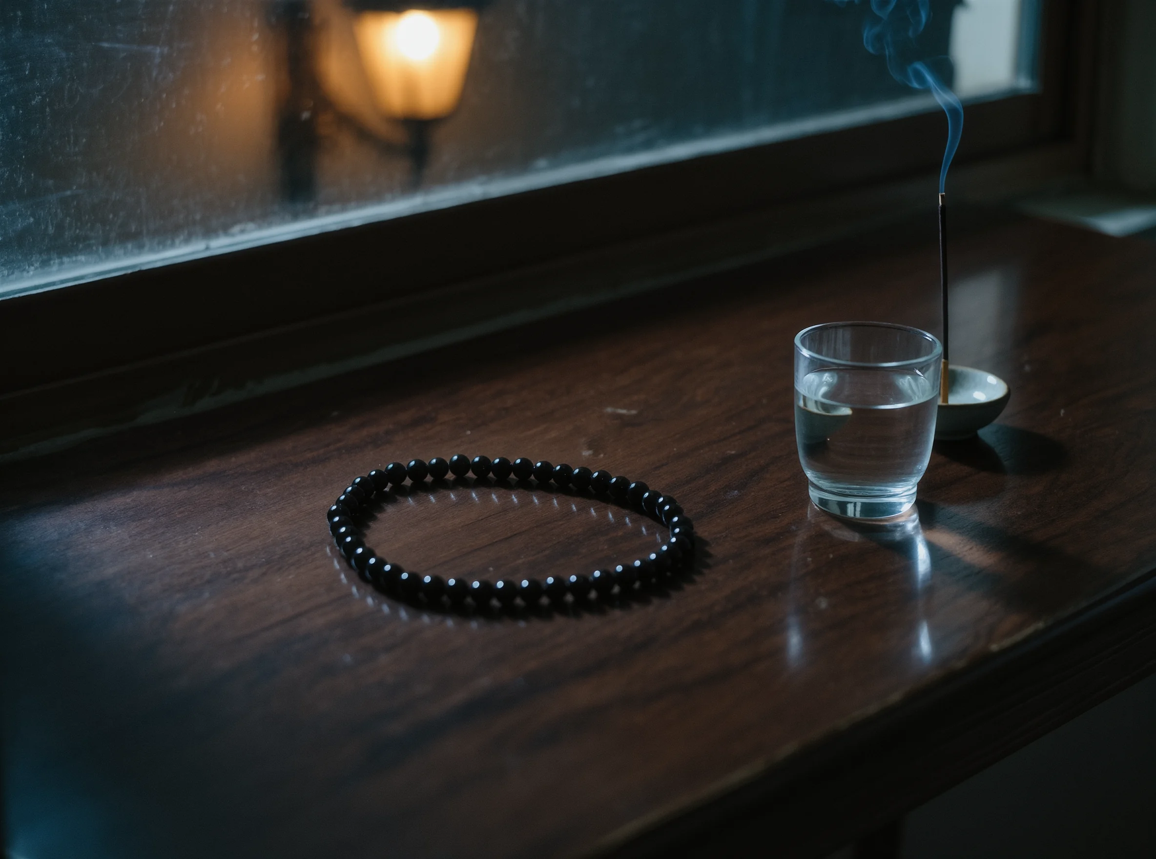 The Evening Descent: Returning the Weight to the Altar 2 Evening Ritual by Yuano: A sacred obsidian necklace on a wooden altar at dusk