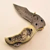 HANDMADE DAMASCUS STEEL RAIN DROP PATTERN FOLDING KNIFE WITH BONE HANDLE EAGLE ENGRAVED ON IT.