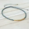 Adjustable friendship bracelet cotton string in twist design and gold plated on sterling silver beads at the center