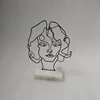 Decorative metal wire face object with marble base